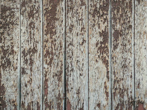 雨風で剥がれた木目の古い板壁
