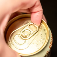 缶ビールのSOT（ステイオンタブ）に指をかける瞬間の写真