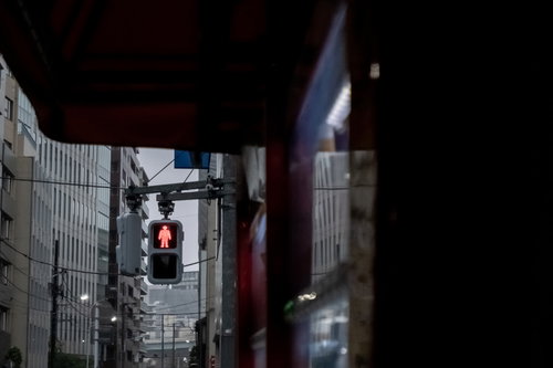 赤く点灯した歩行者信号の止まれ表示と横断歩道