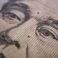 布地に置かれた一万円札の福沢諭吉肖像と金銭の写真