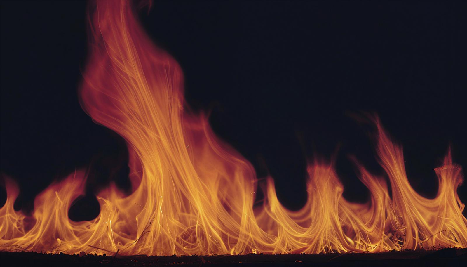 Intense red and yellow flames engulfing a dark background