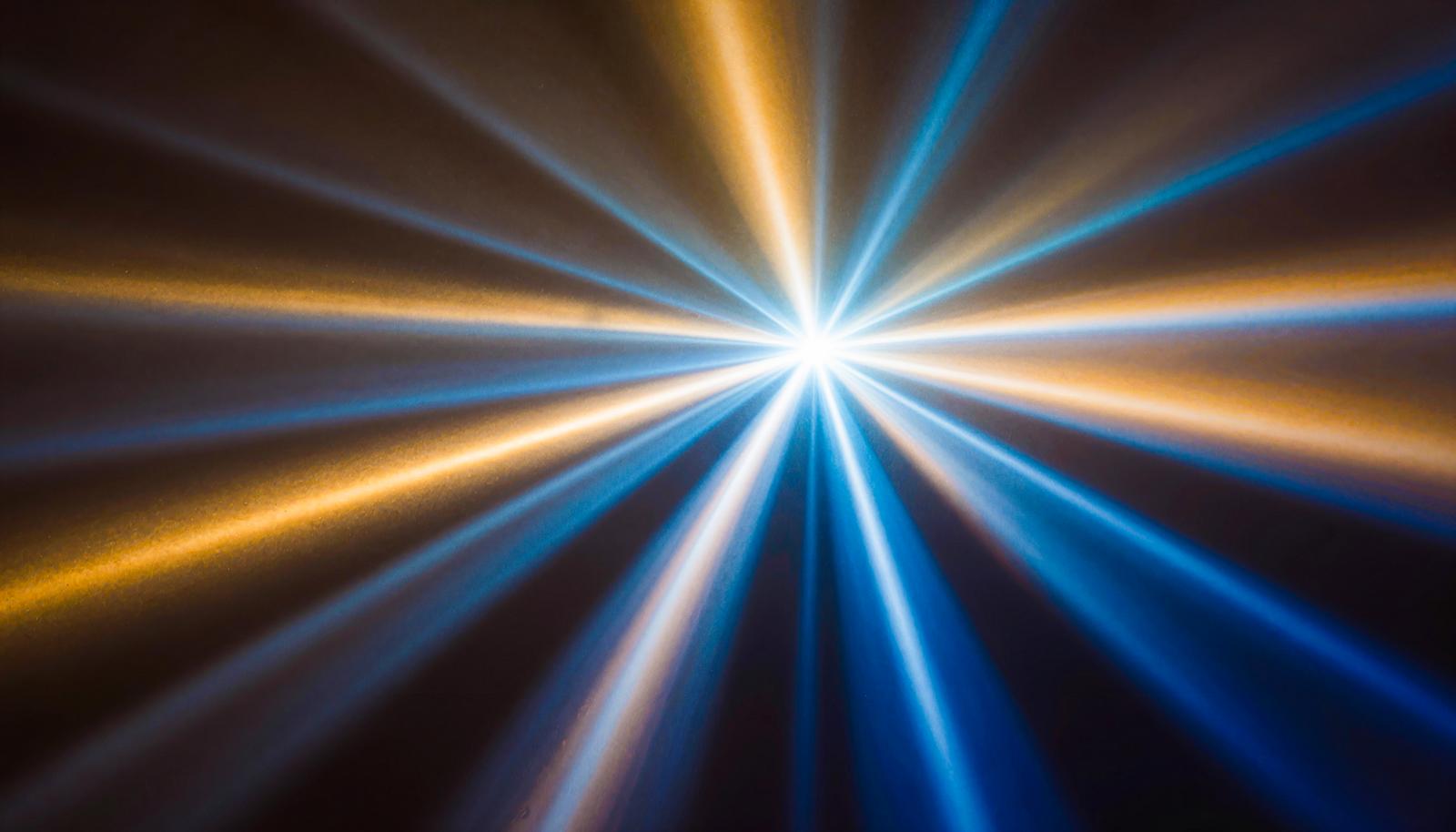Radiant blue and orange light trail effect spanning across the frame