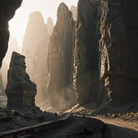 積み重なった巨大な断崖に囲まれた古代遺跡風景と石造の彫像の写真