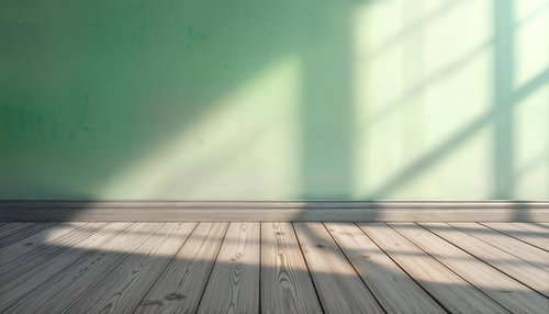自然光が差し込む緑の壁と木の床
