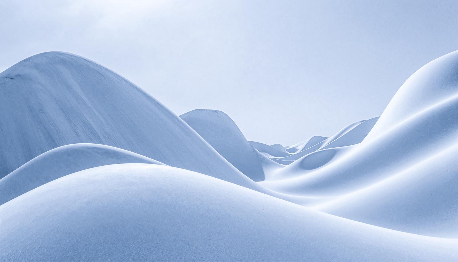 Snow dunes stretching across a winter landscape