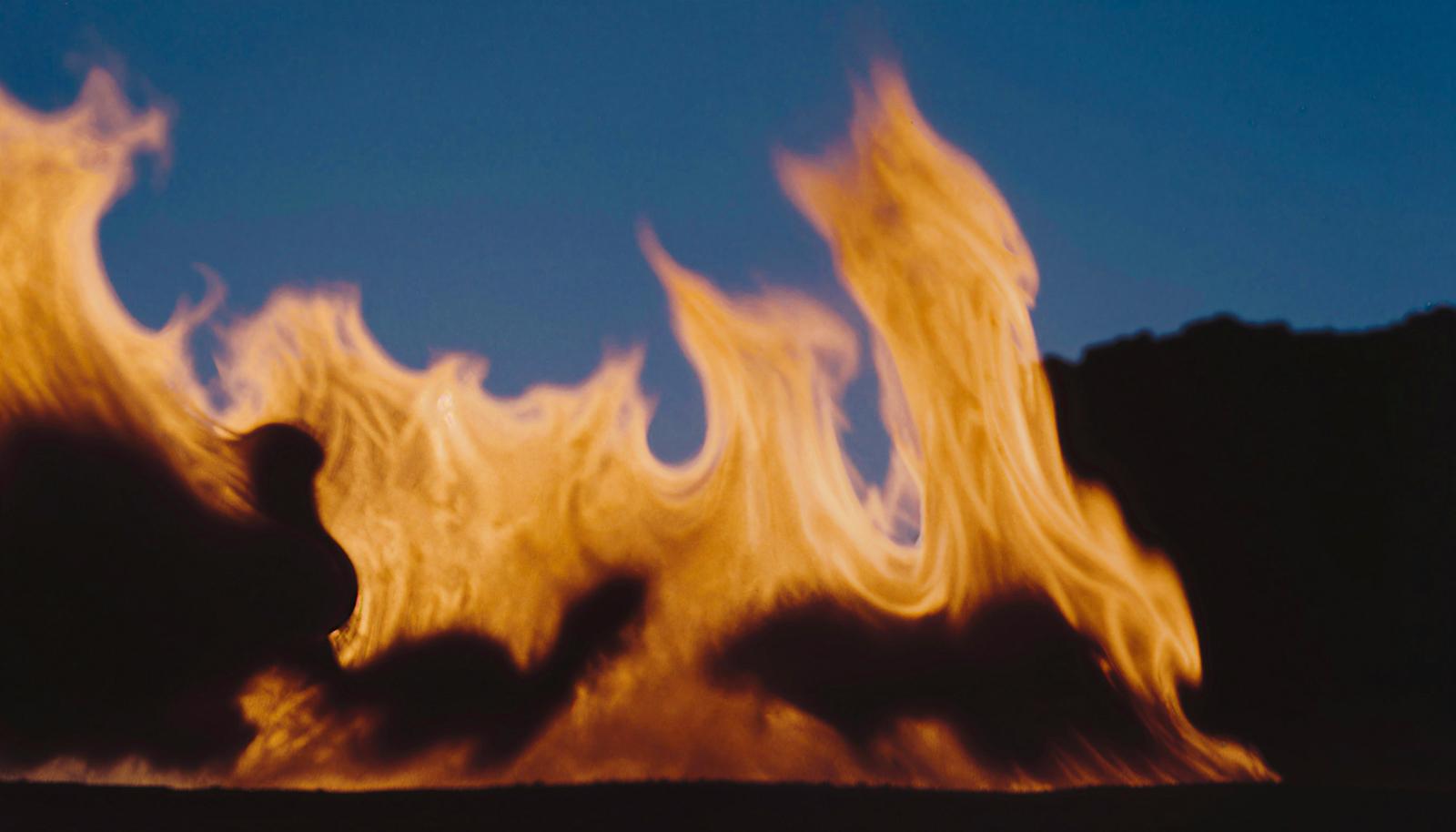 Large flames blazing against a night sky