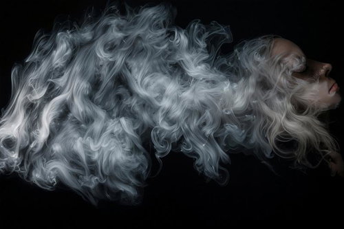 黒背景に白いスモークが流れる煙のエフェクト