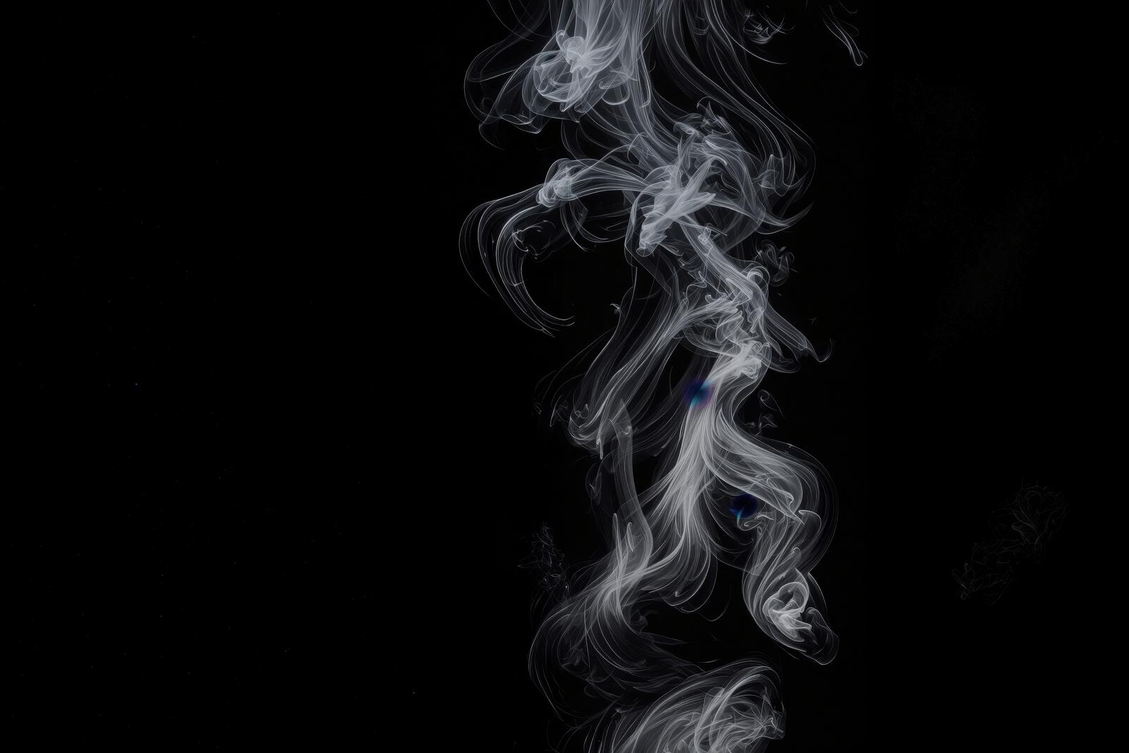 黒い背景に白い煙が立ち上り流線的な形状を描いている様子
