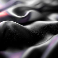 滑らかな黒布の起伏に舞うシルクの抽象美と光の表現の写真