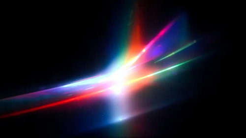 黒背景に放射状に広がる虹色のレンズフレア光線
