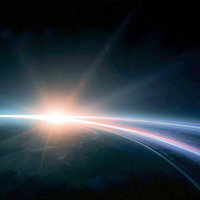 宇宙から見た地球と日の出の写真