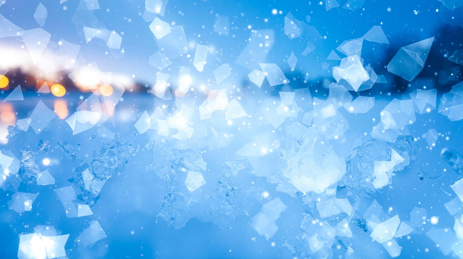 青い背景に氷の結晶と光る粒子が舞うデジタル画像