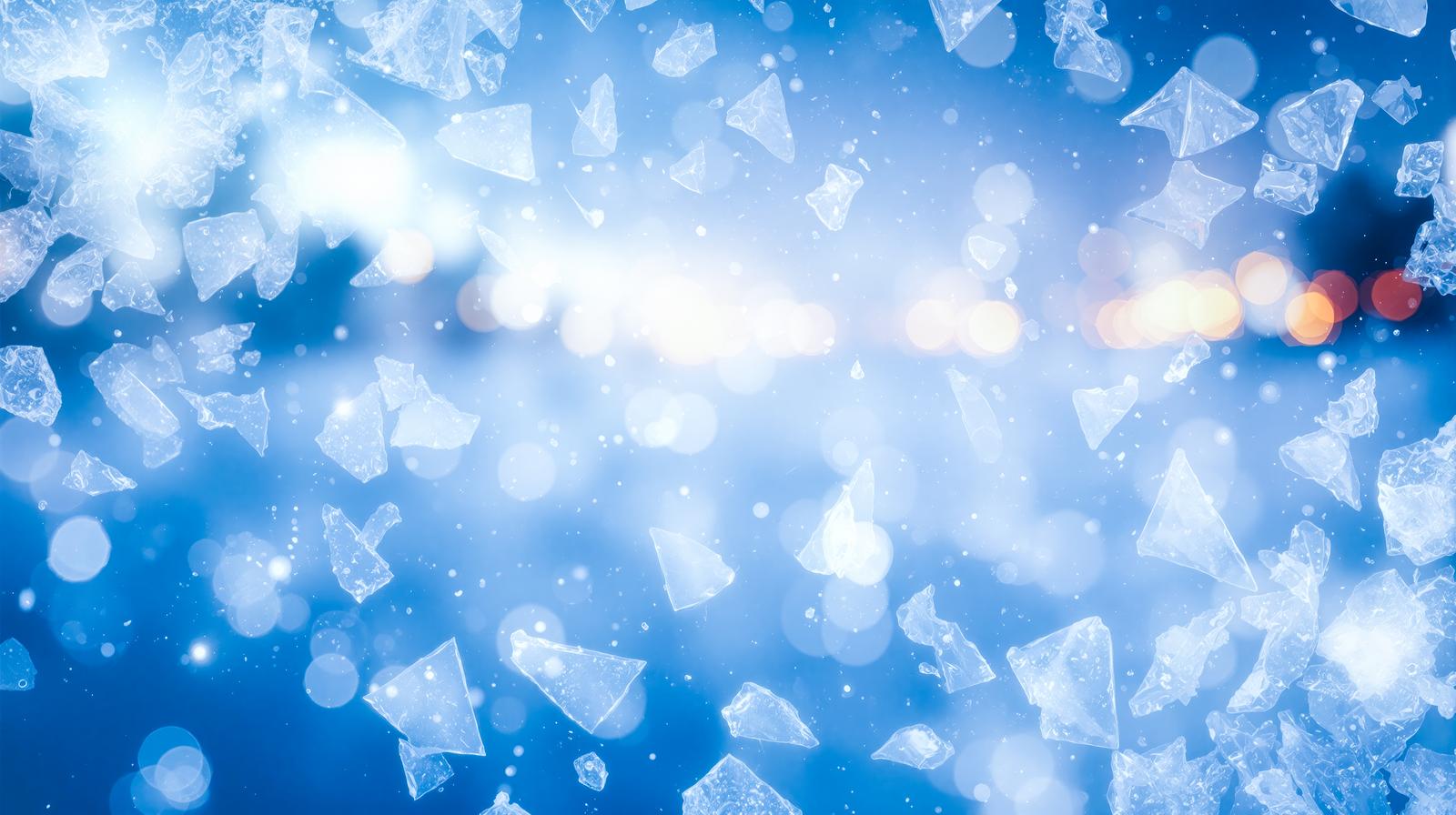 青い背景に氷の結晶が舞い散り光がきらめく様子