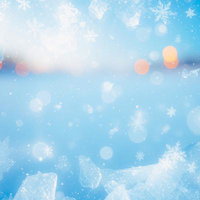 青い背景に雪の結晶と暖色の光が舞う冬の抽象的な結晶模様の写真