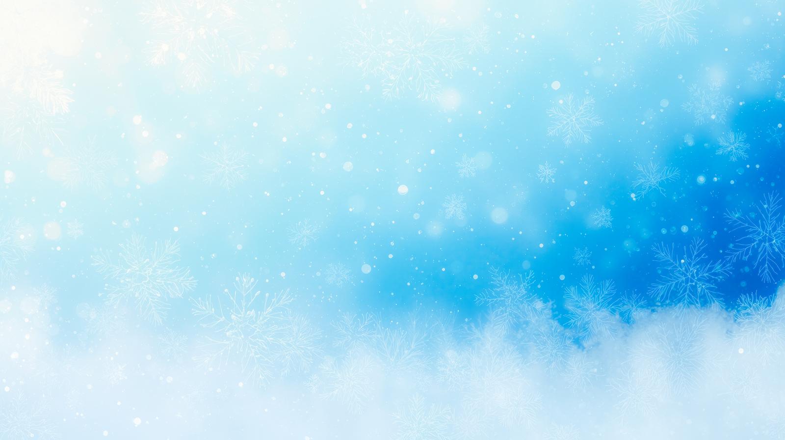 青い空に雪の結晶が舞い散り白い雲が浮かぶ冬の幻想的な風景