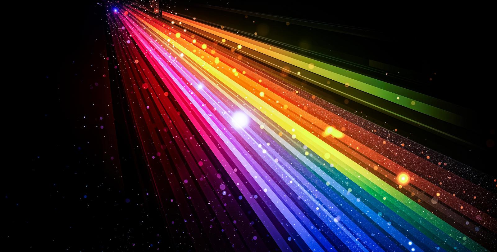 Seven-color light rays radiating outward with scattered light particles against a black background