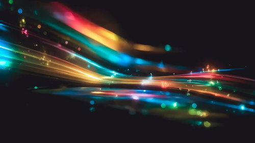 闇に輝く虹色の光跡と粒子が流れるネオン背景