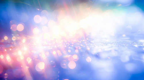 ピンク色から青色へのグラデーションが流れるボケの光と輝き