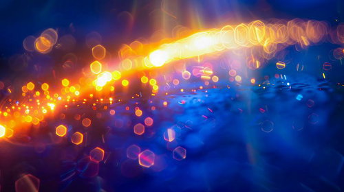 青とオレンジが交差する光の軌跡デザイン・ボケと輝きのライトトレイル