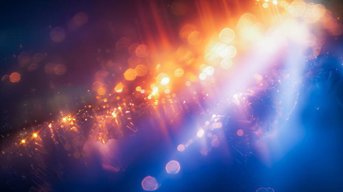 レンズフレアが差し込む光の粒子 オレンジから青紫へのグラデーション