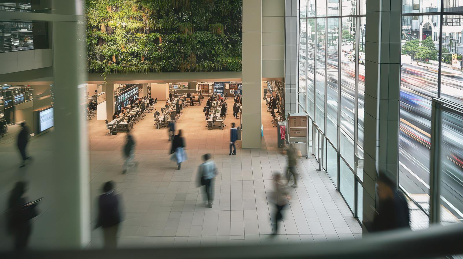 商業施設風のワークスペースで人物が行き来する様子