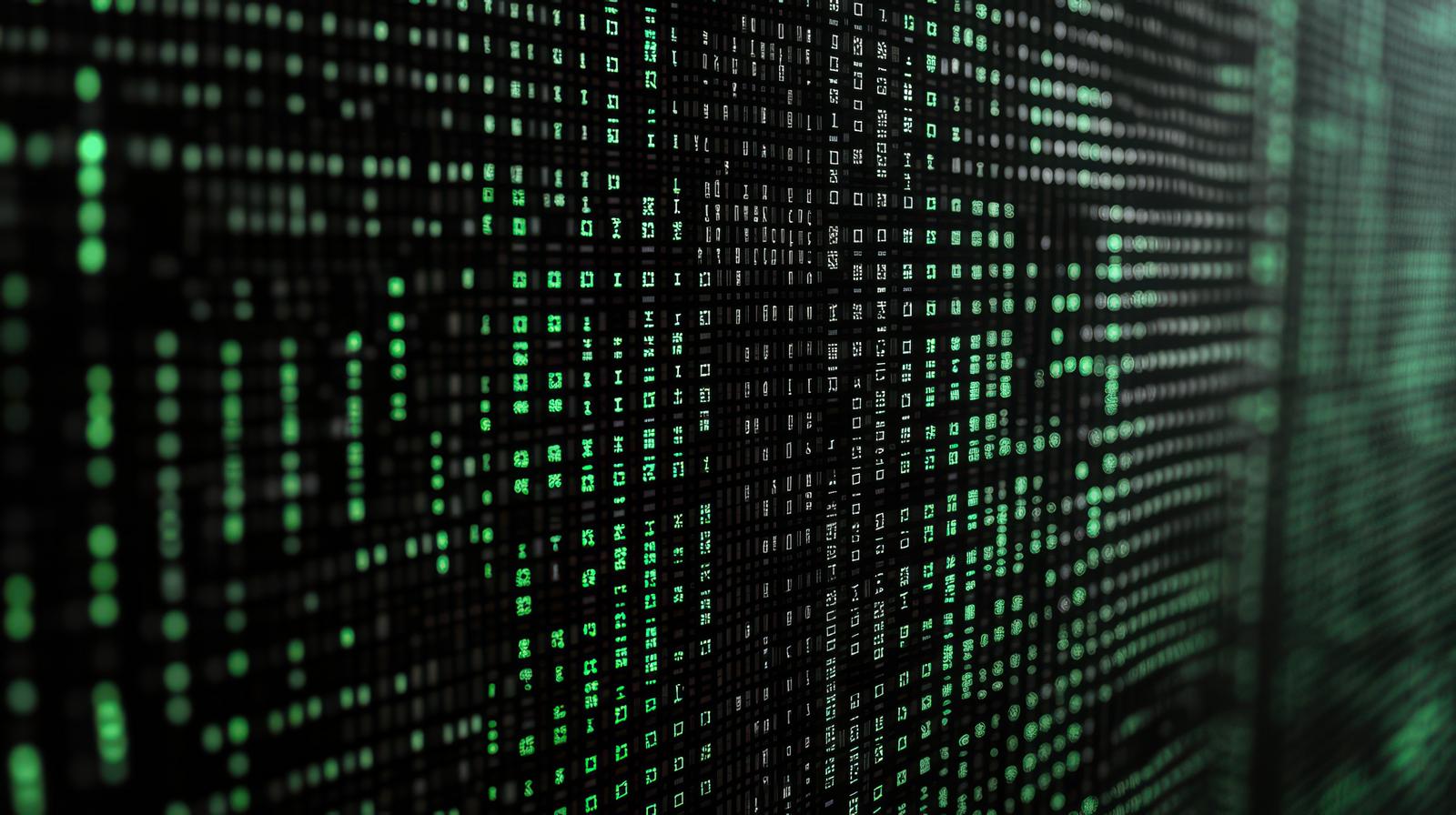 黒い背景に緑色のバイナリコードが縦に流れている画面