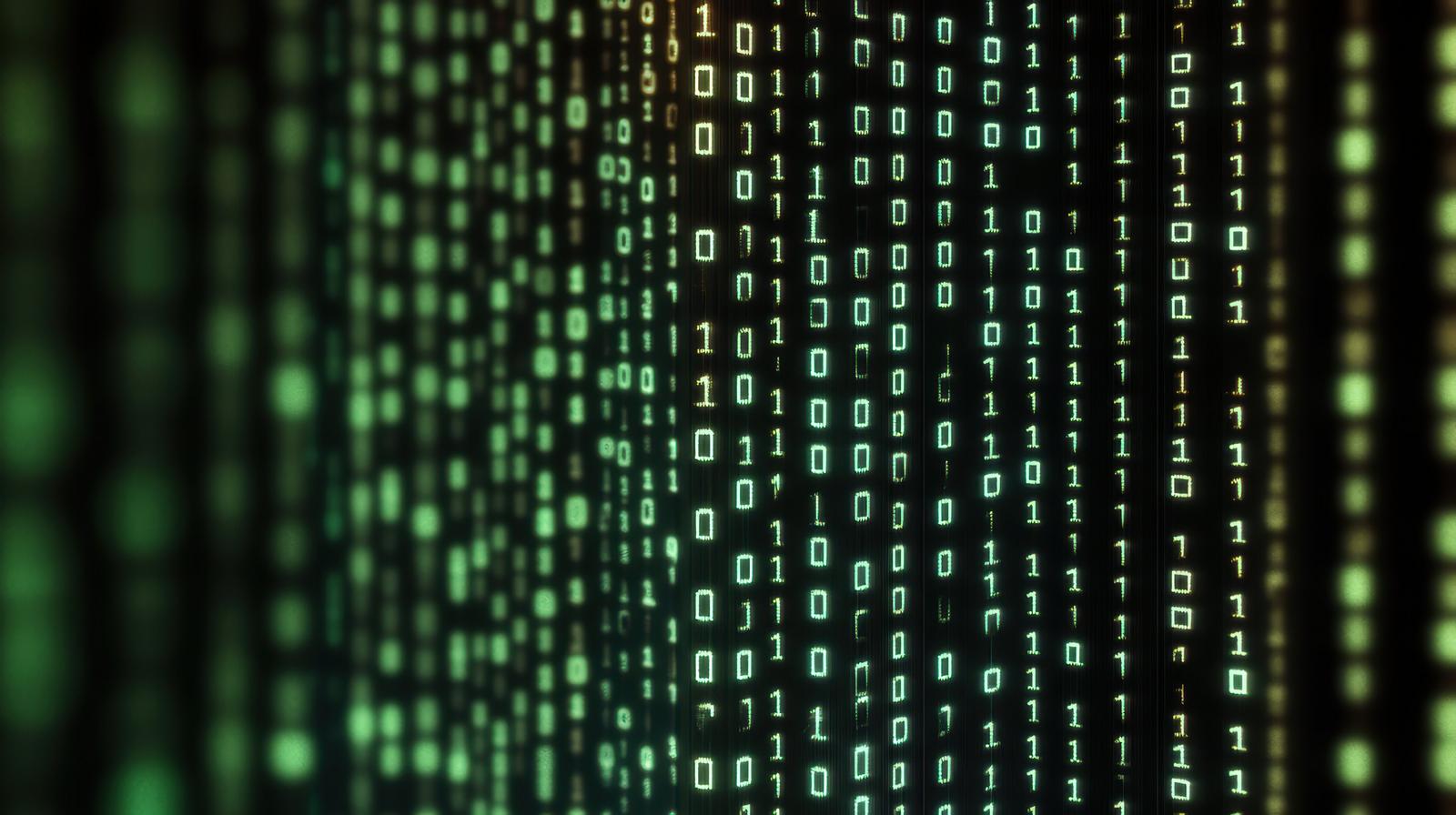 A digital screen with vertically flowing green binary code in a matrix-style design