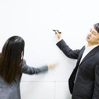 ホワイトボードに書いたマトリックス図を秒速で削除する女性の写真