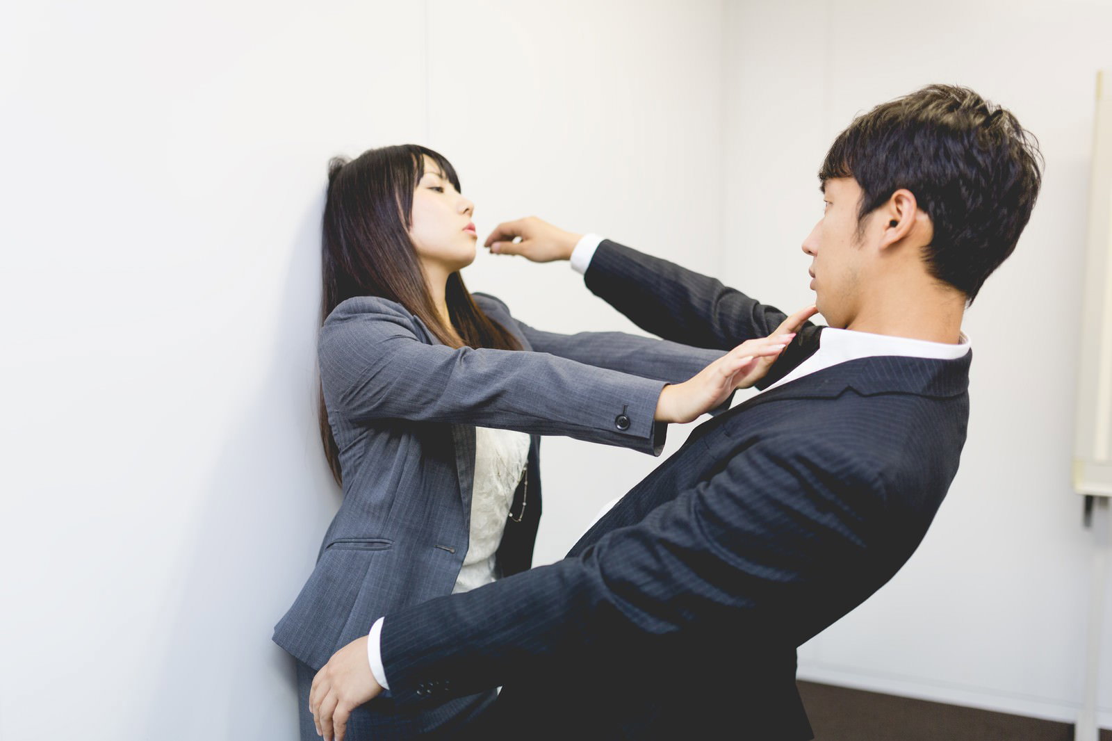オフィスで女性部下に突き飛ばされ、かわそうとする男性上司［モデル：大川竜弥 Lala］