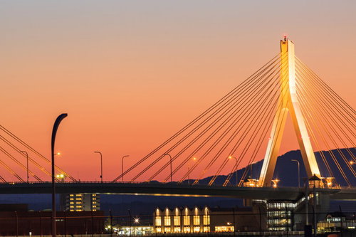 青森ベイブリッジと夕焼けに染まる街並みと港の風景
