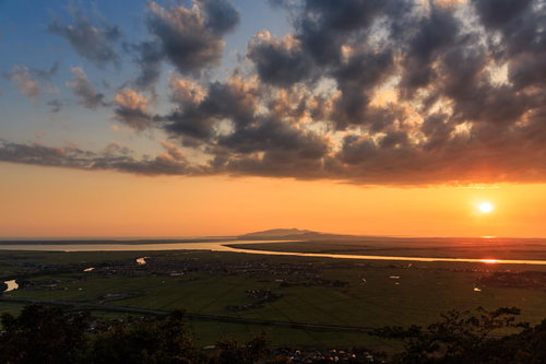 八郎潟に沈む夕日と雲、水面に映る金色の光景