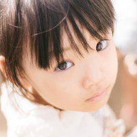 白い服を着た愛娘の上目遣いポートレートの写真