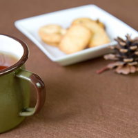 お皿に盛られたお菓子とカップのおやつの時間の写真