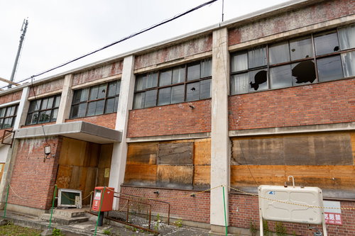 窓ガラスが割られ老朽化した美唄市我路郵便局の廃墟