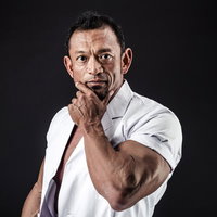 出勤前に鏡で身だしなみを確認する歯科医の男性の写真