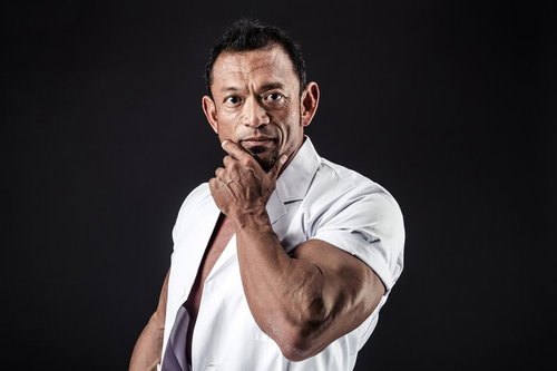 出勤前に鏡で身だしなみを確認する歯科医の男性