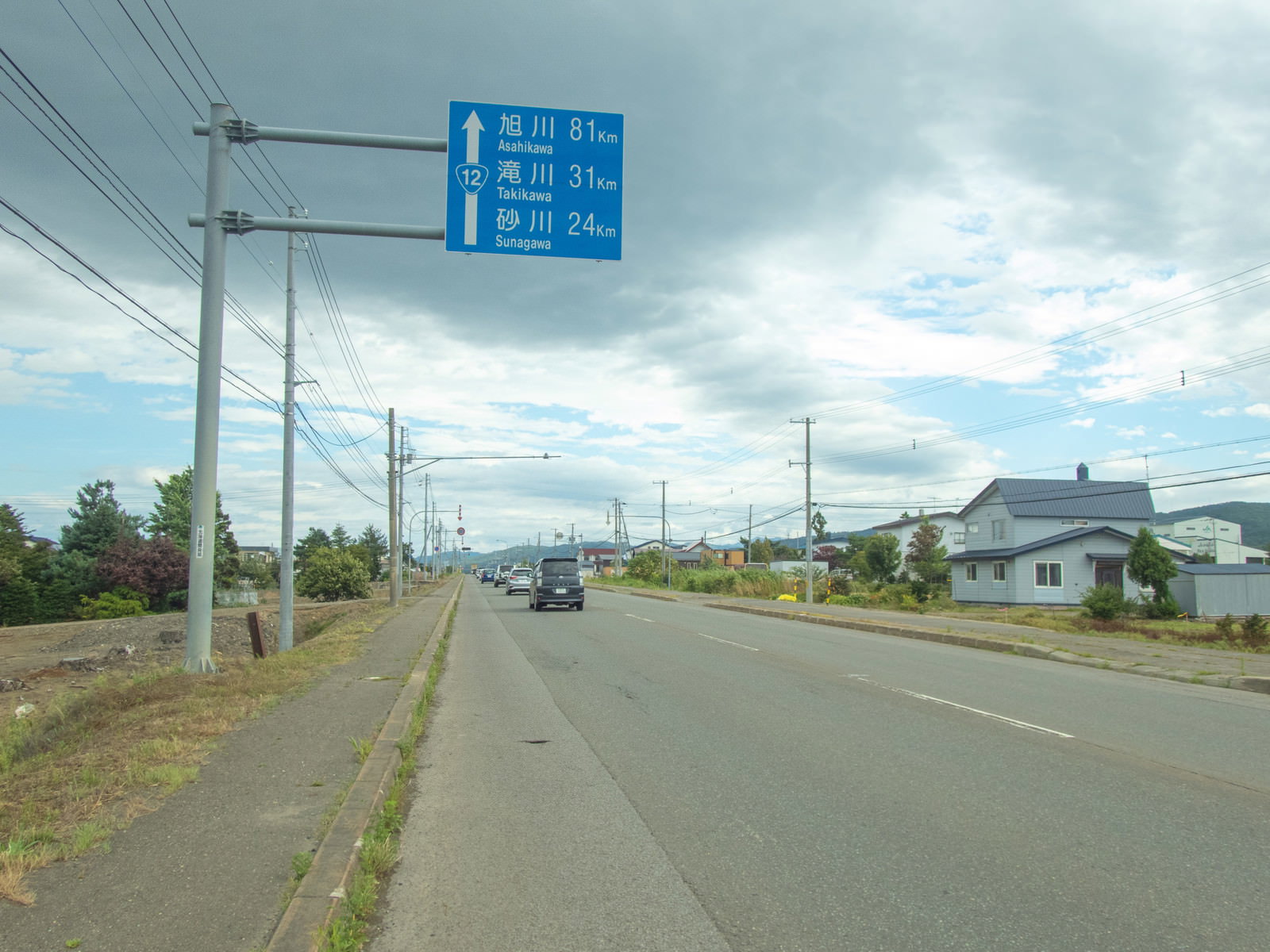 Vehicles traveling on the longest straight road in Japan, National Route 12 in Bibai City, Hokkaido