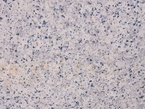 淡いピンクとグレーの花崗岩のテクスチャー