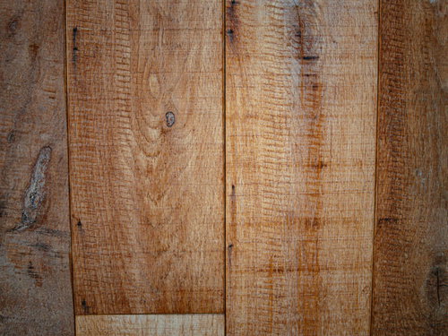 引きずった跡が残る茶色い木目板のテクスチャー