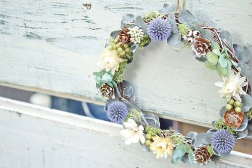 結婚指輪の周りに白い花が飾られたリングのブーケ