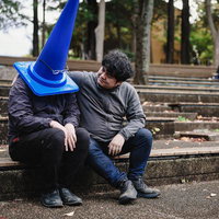 仲間が外れない呪いのアイテムを装備したと聞いて、項垂れる男性の写真