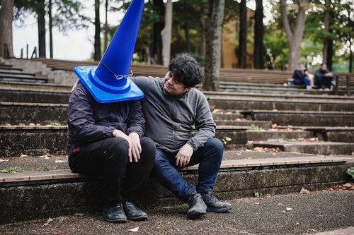 仲間が外れない呪いのアイテムを装備したと聞いて、項垂れる男性