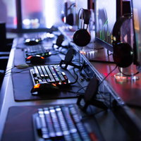 PCゲーム用のキーボードとモニターが並ぶeスポーツ施設の対戦卓の写真