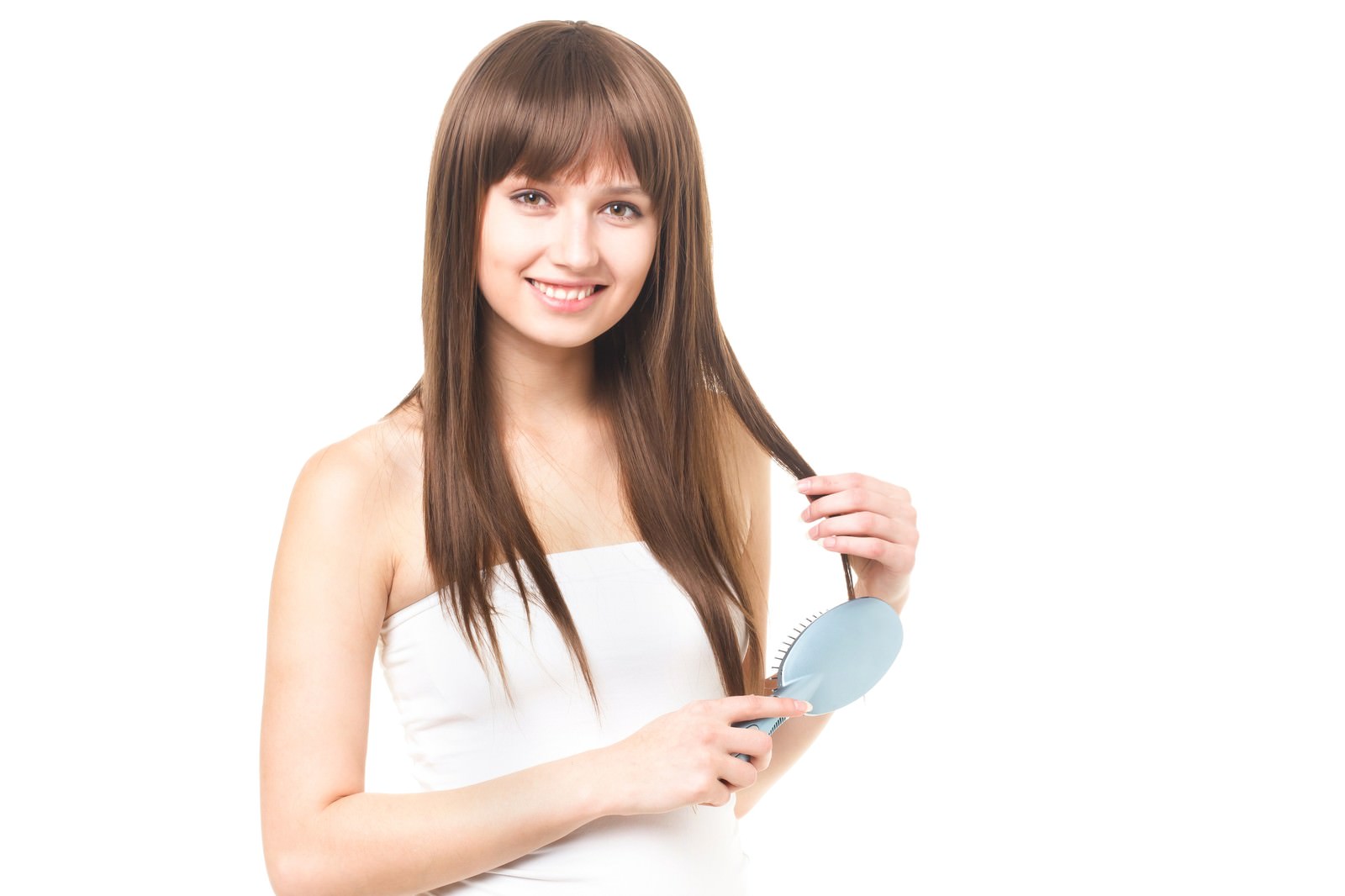 水色のヘアブラシで髪をとかす笑顔の女性［モデル：モデルファクトリー］