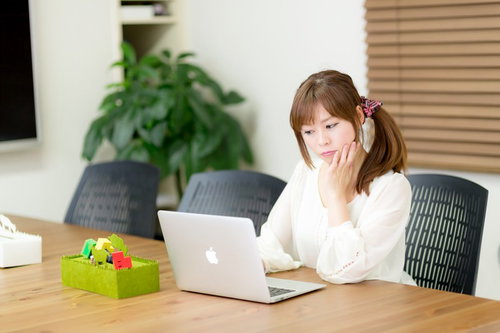 電源完備のコワーキングスペースで作業をする女性