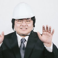 落ち着いて、落ち着いて、と両手で制止するヘルメット姿の男性の写真
