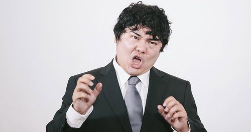 スーツ姿で力説する男性