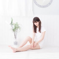 ふとももを両手で触る色白の女性、スキンケアとボディケアの写真