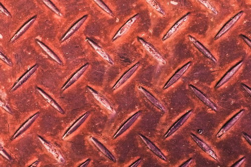 赤く錆びた金属製の足場テクスチャー素材背景