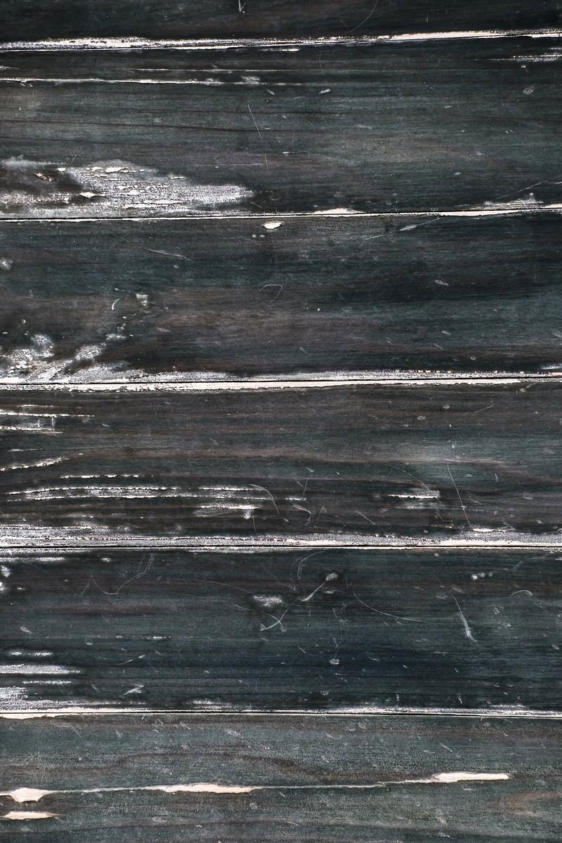 白い塗装が筋状に剥がれた古い木板のテクスチャー